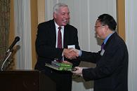 Jon Geiger and Yuanmu Yu exchanging gifts